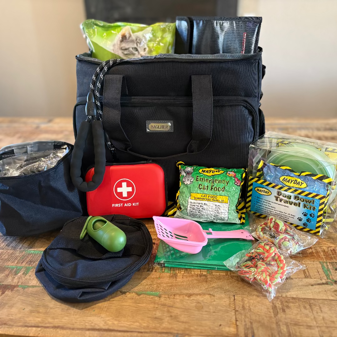 Black bag with first aid kit and various supplies on a wooden table