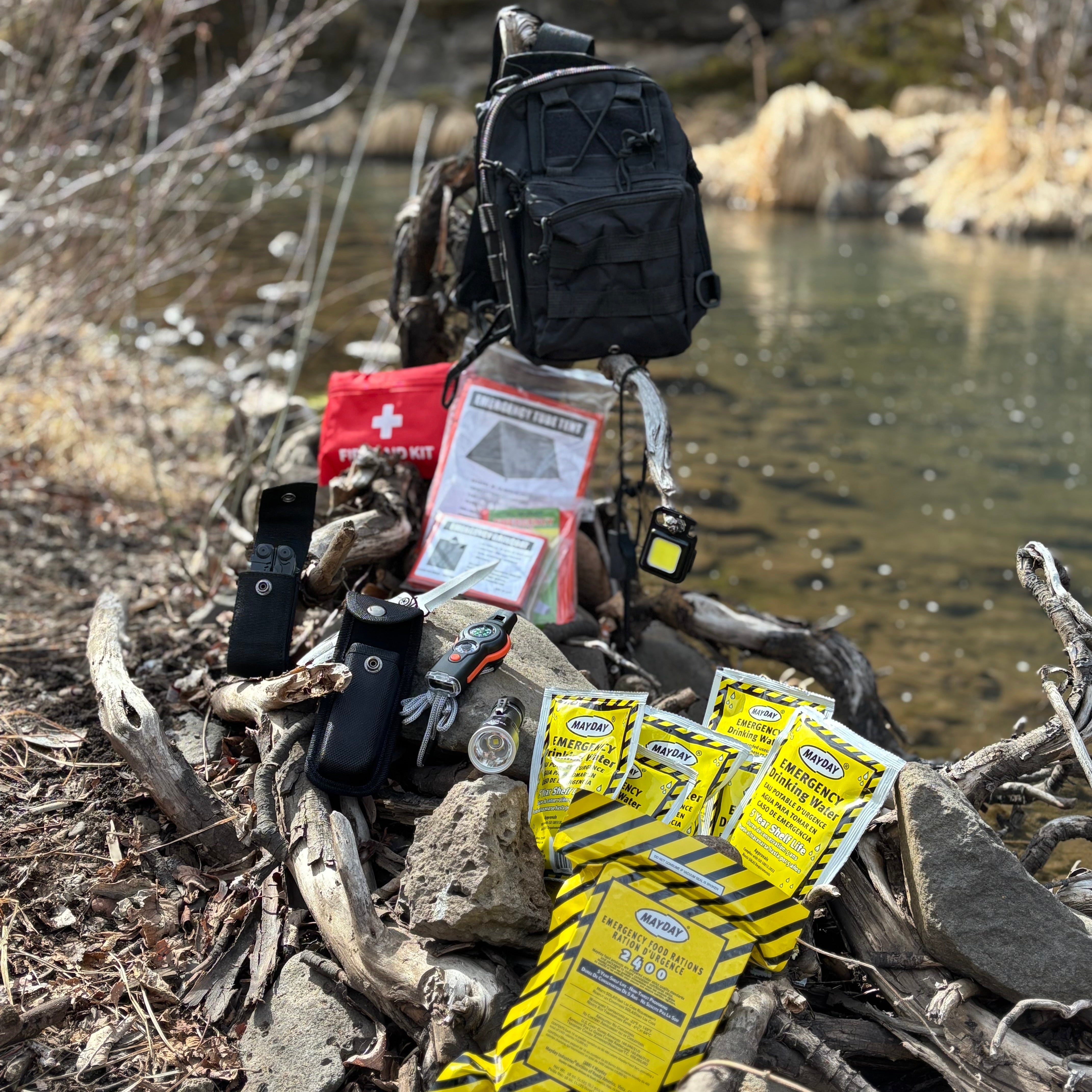 Backpack and emergency supplies on a log near a body of water